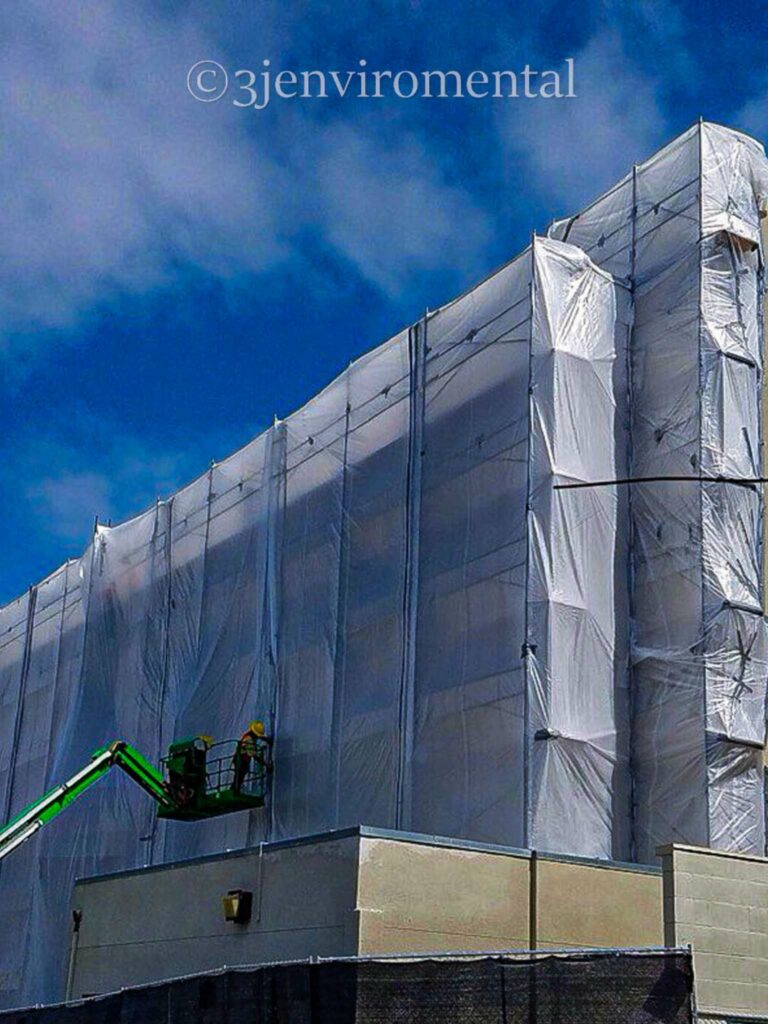 Inspector using XRF equipment to detect lead-based coatings on building surfaces in Los Angeles, California.