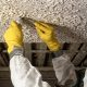 A trained environmental technician performs solid asbestos sampling on construction materials to ensure safe renovation and demolition practices in Los Angeles, CA.